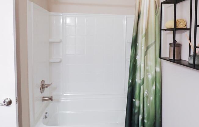 a bathroom with a white tub and a shower curtain