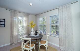 a dining room with a table and chairs and windows at Radbourne Lake Apartments, Charlotte, 28269 ? 