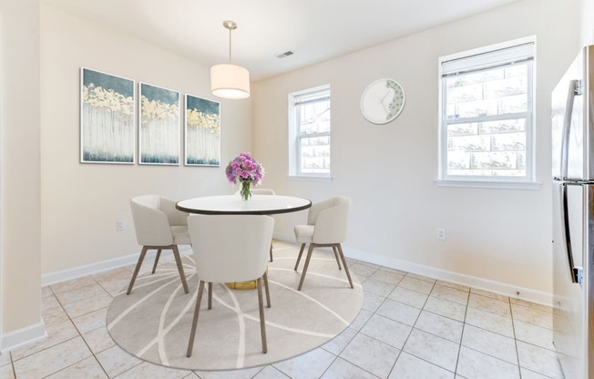 dining area with table, chairs, windows and tile flooring at sheridan station south townhomes in washington dc