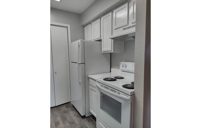 a kitchen with a stove top oven sitting inside of a refrigerator