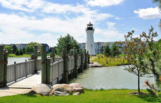 Community Lake with Crossing Bridge and Lighthouse at The Harbours Apartments, Clinton Twp, 48038