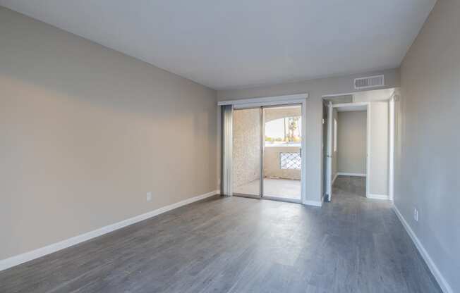 a bedroom with hardwood floors and beige walls  at Sofia Apartments, Tempe, AZ