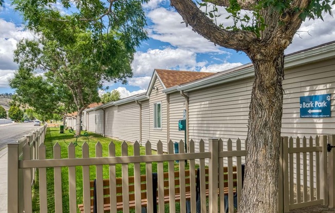 a row of houses with a fence and a tree