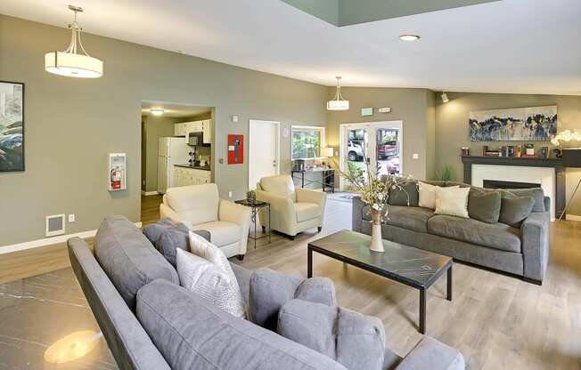 a living room with couches and chairs and a fireplace