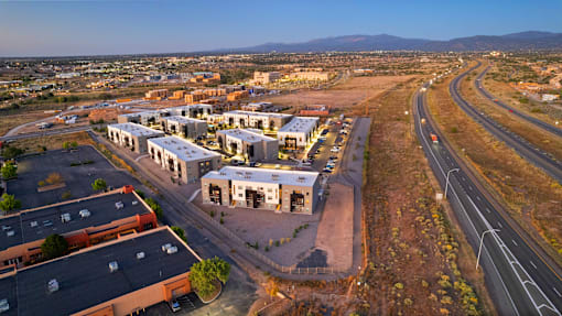 A road with a highway going through a town with buildings on the side.