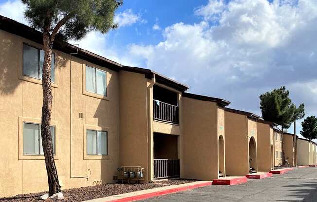 Apartment complex with a tree in front of the first building.