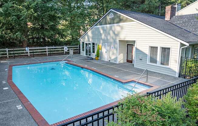 A small house with a pool in the backyard.