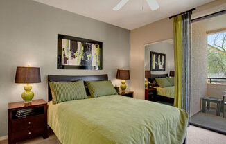 a bedroom with a bed and a ceiling fan