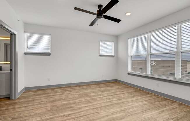 a living room with a large window and a ceiling fan at Meridian at CityPlace, Woodbury Minnesota