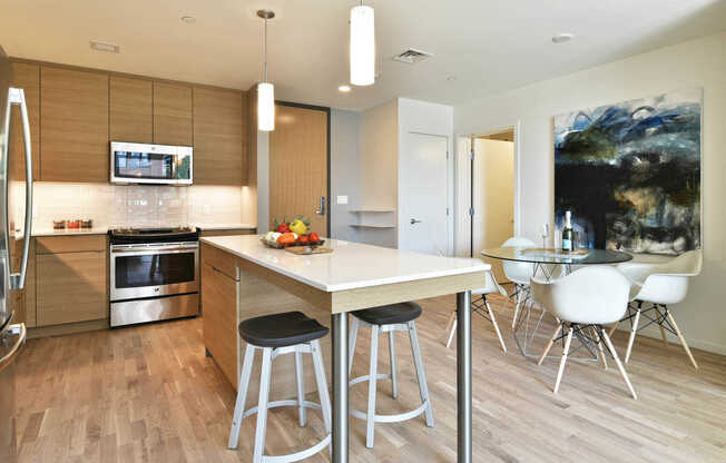 Kitchen with Glass Tile Backsplash and Stainless Steel Appliances