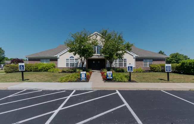the front of a house with signs in the parking lot