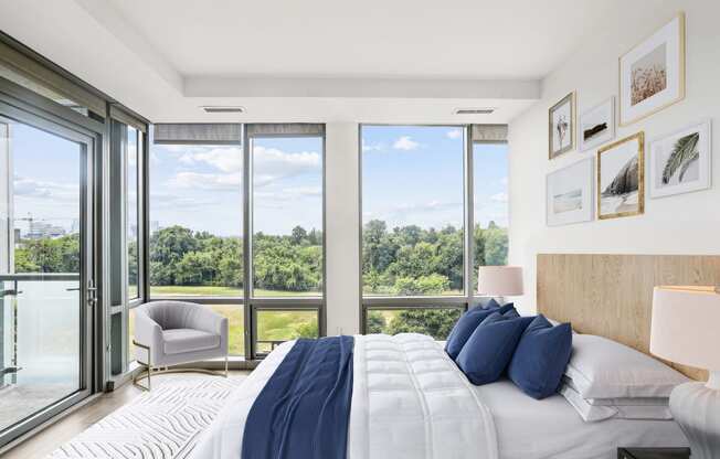 a bedroom with a bed and a view of a large window