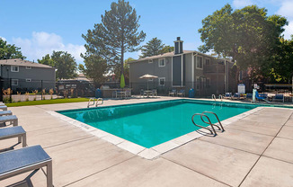 Community Swimming Pool with Pool Furniture at Overlook Apartments located in Salt Lake City, UT.