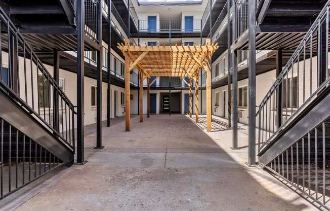 the corridor inside of a building with stairs and a wooden structure