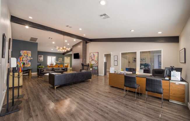 Community room with couches and chairs and a table with a computer at 2900 Lux Apartment Homes, Nevada