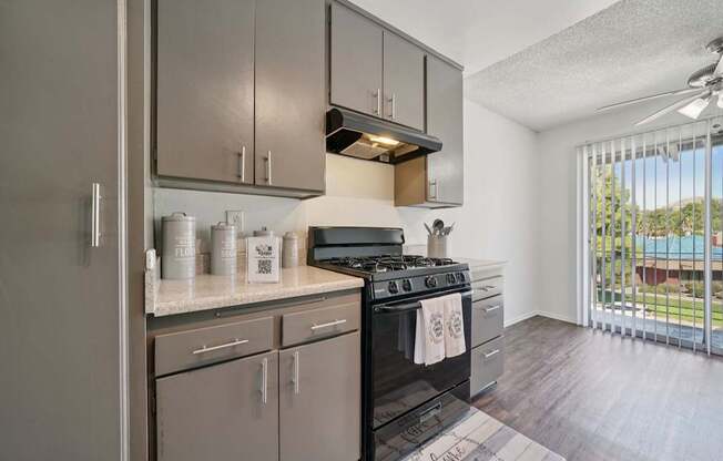 A modern kitchen with a black stove top oven.