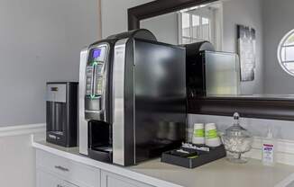 a kitchen with a coffee maker and a microwave on a counter