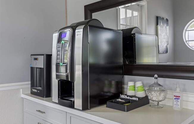 a kitchen with a coffee maker and a microwave on a counter