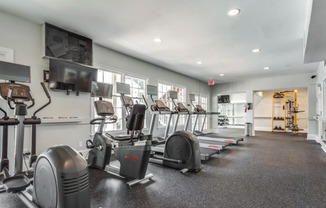 A spacious gym with a variety of exercise equipment.