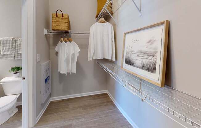a large walk-in closet with racks and shelves