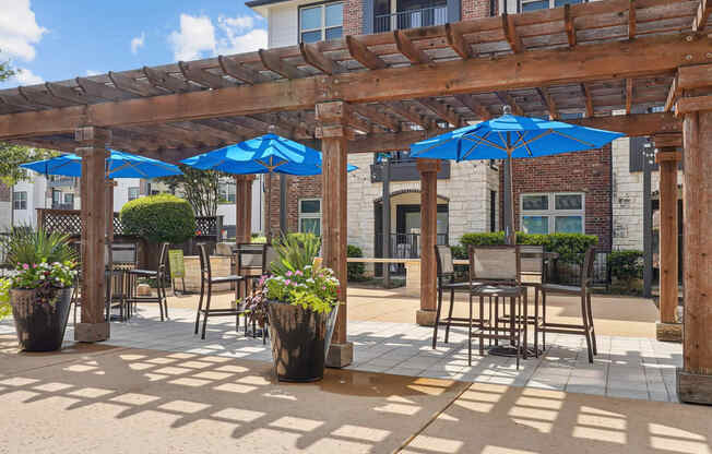 a patio with tables and chairs and umbrellas