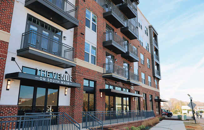 The Venue on South Main is a red brick building with black railings and balconies.