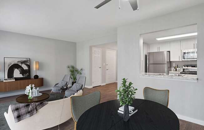 Model Living/Dining Room with Wood-Style Flooring and View of Kitchen at Overlook Point Apartments in Salt Lake City, UT.