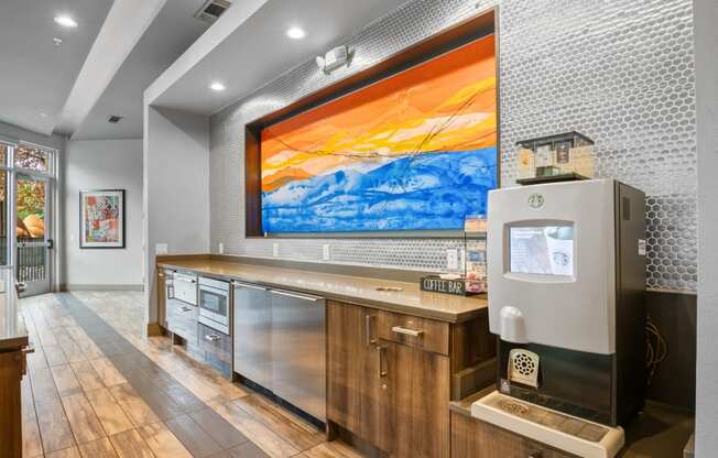 a wet bar with a refrigerator and a painting on the wall at South Side Flats, Dallas, Texas
