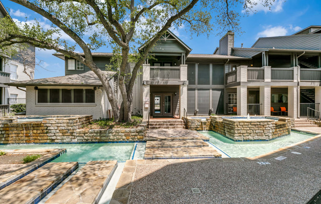 a house with a swimming pool and a tree in front of it