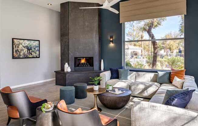 a living room with couches and chairs and a fireplace at Mirasol Apartments, Las Vegas, NV