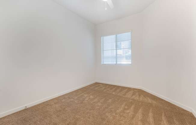 an empty room with carpet and a window at Metro Gateway, Riverside, 92503
