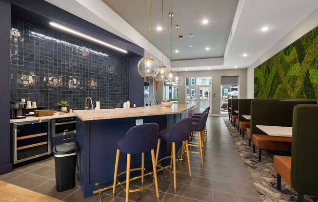 A modern kitchen with a bar area and a green wall.