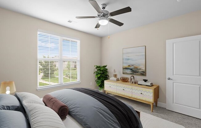 a bedroom with a bed and a ceiling fan