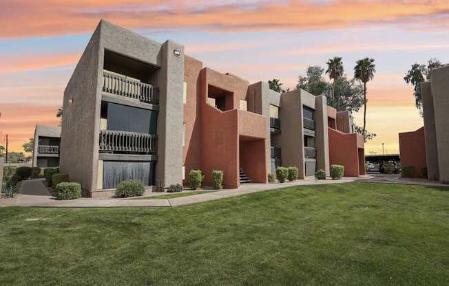 A modern building with a green lawn in front.