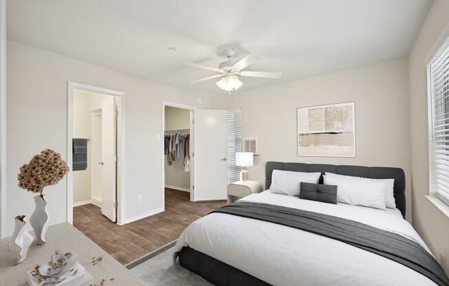 a bedroom with a large bed and a ceiling fan