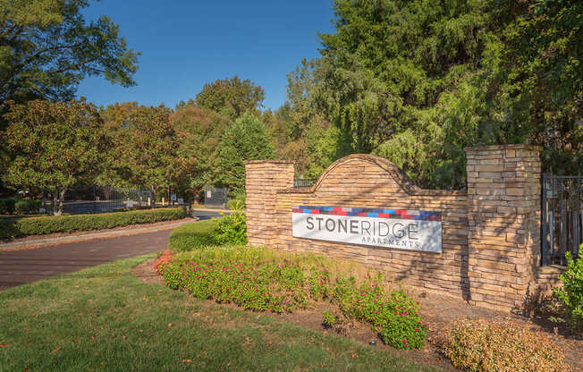 A sign for Stoneridge Apartments is displayed in front of a building.