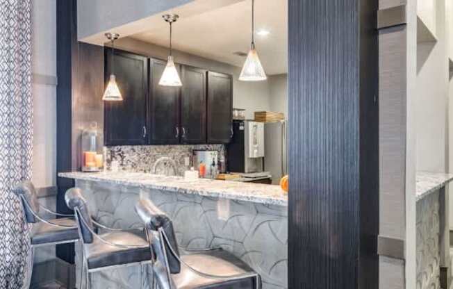 A bathroom with a vanity and a chair.