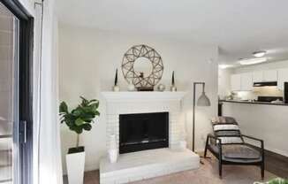 A living room with a fireplace and a chair.