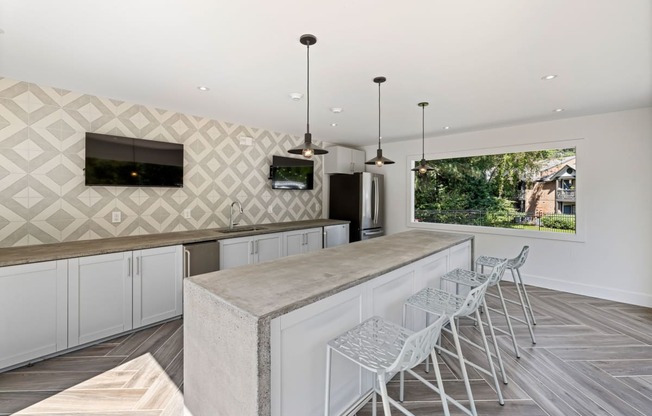 a large kitchen with a long counter and bar stools at View at Lake Lynn, Raleigh, NC