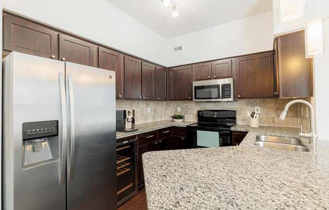 a kitchen with stainless steel appliances and granite counter tops