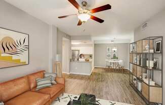 a living room with a couch and a ceiling fan