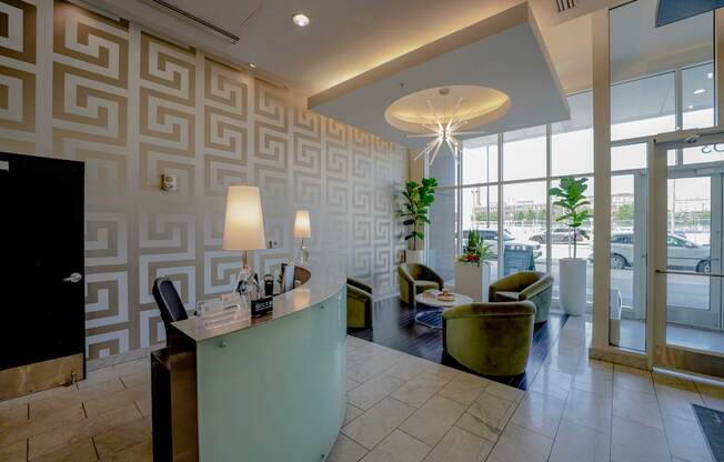A reception area with a green desk and a black door.