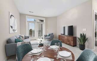 A modern dining room with a wooden table set for two.