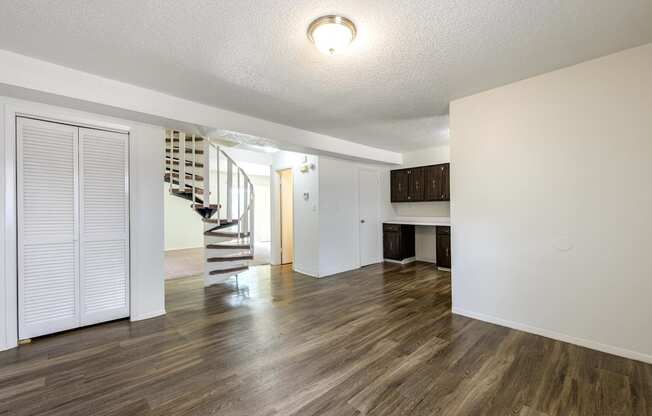 A room with wooden floors and white walls at Spring Creek Townhomes Apartments, Springfield, Illinois