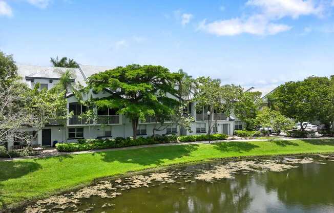 an apartment building sits next to a body of water