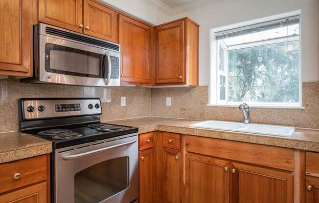 Village at Main Street | 2x2 Kitchen with Wood Cabinetry and Stainless Steel Appliances