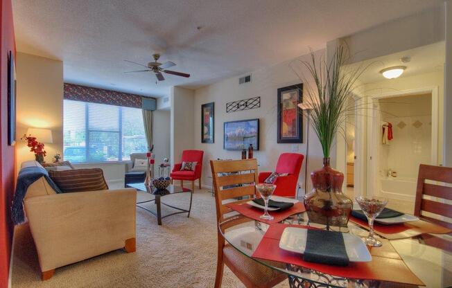 Vue Park West Living Room and dining room with wall to wall carpet and ceiling fan