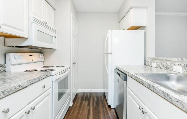 a kitchen with a stove sink and refrigerator