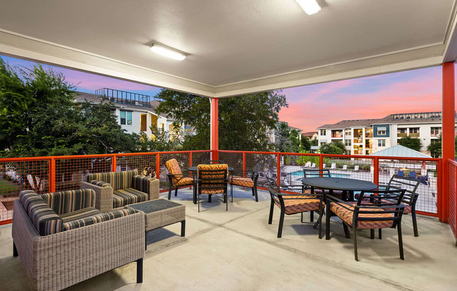 a patio with chairs and tables on a balcony