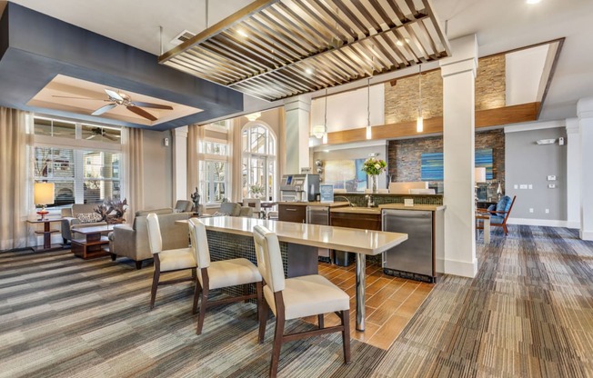 A modern kitchen with a dining table and chairs.at Century Hampton Roads, Suffolk, VA  